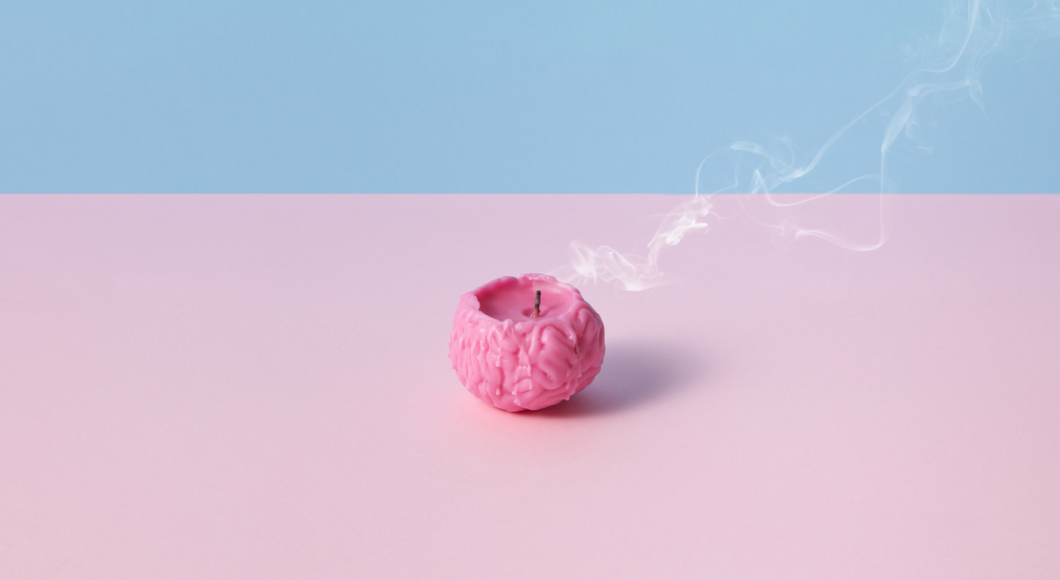 pink candle that is shaped like a brain almost burnt out